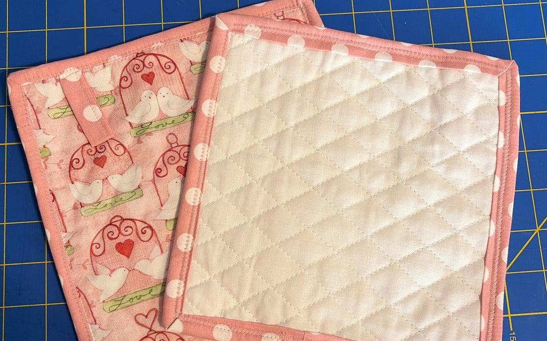 Pink Lovebirds quilted cotton potholders, set of 2, back showing quilted backing